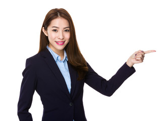 Young businesswoman showing finger point aside