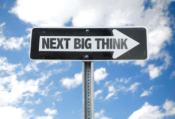 Next Big Think direction sign with sky background