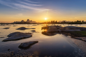 Beautiful sunset landscape with seascape and stone