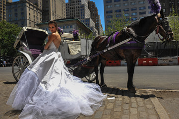 Model Kalyn Hemphill poses in front of horse carriage at the Irina Shabayeva SS 2016 Bridal...