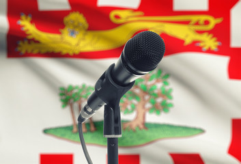 Microphone on stand with Canadian province flag on background - Prince Edward Island