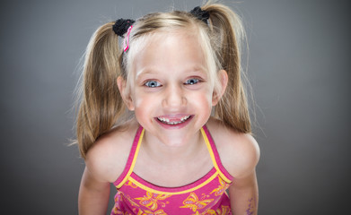 Portrait of cute smiling little girl without teeth.
