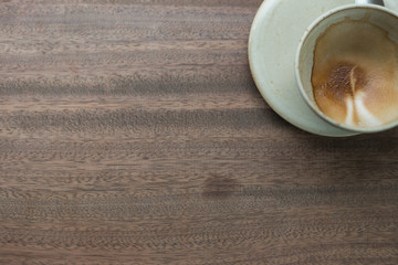 empty coffee cup wiht coffee stain on wooden table