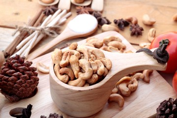 Roasted cashews nuts with natural on wood background