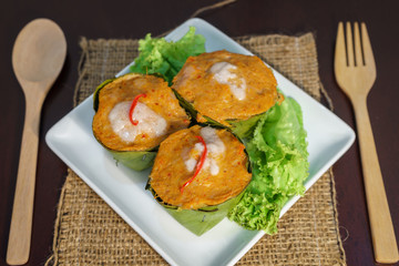 Fish curry in banana leaves serve in white plate