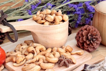 Roasted cashews nuts with natural on wood background