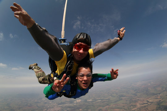 Skydivers. Boy and girl tandem jump