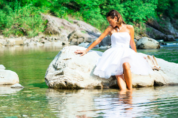 Lonely bride in a rock by the river