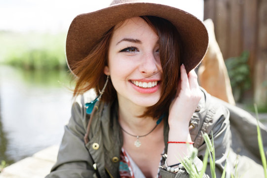 Bright stylish lifestyle portrait of pretty girl posing at hat.
