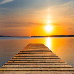Naklejka na ściany i meble wooden wharf on a sunset