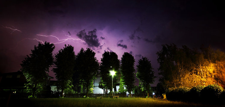 Outdoor summer storm with lightning, viewed from a metropolitan garden. Caselette Italy.