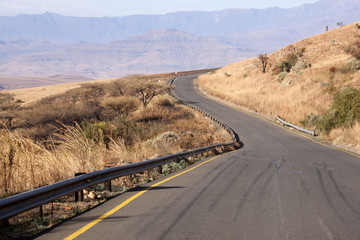 Asphalt Road on Mountain Pass Overlooking Valley Below