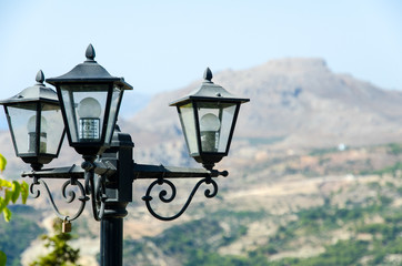 Fototapeta na wymiar Black lantern against the backdrop of the mountains