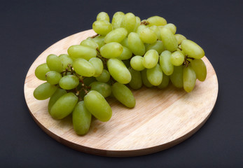 Grapes on cutting board.