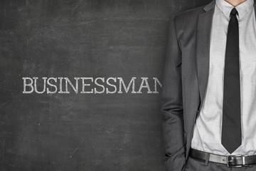 Businessman on blackboard
