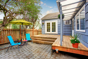 Perfect back deck with concrete patio and chairs.