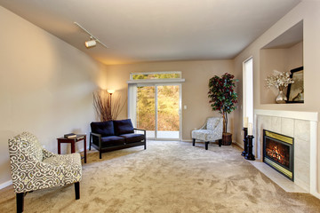 present day living room with carpet and fireplace.