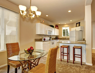 Contemporary dinning room with carpet, and glass table.
