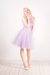 Beautiful woman with blond hair, red lips in the studio.