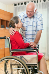 Fototapeta na wymiar woman in wheelchair and elderly man