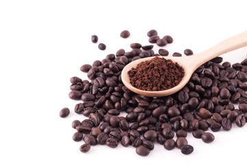 Coffee beans and ground coffee on wooden spoon isolated on white