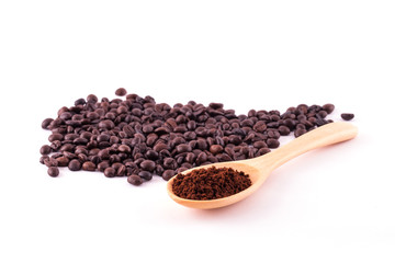 Coffee beans and ground coffee on wooden spoon isolated on white