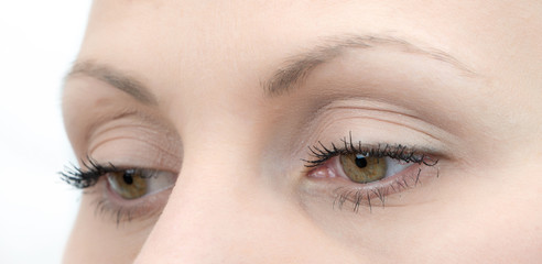Upper part of females face closeup on eyes looking down