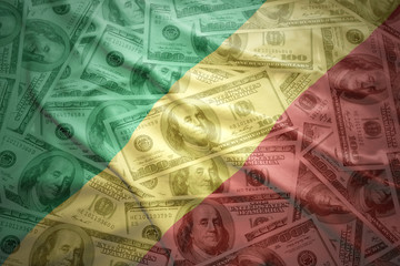 colorful waving congolese flag on a american dollar money background