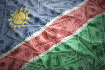 colorful waving namibian flag on a american dollar money background