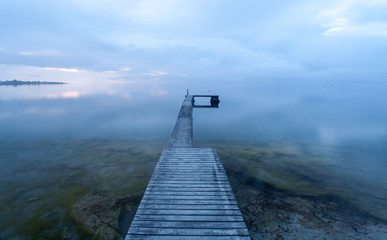 Optical illusion, a bathing jetty seem to float in the air when the sea meets the sky on a magical summer evening at the island of Gotland, Sweden