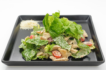 Boiled chicken salad with lettuce leaves isolated on white.