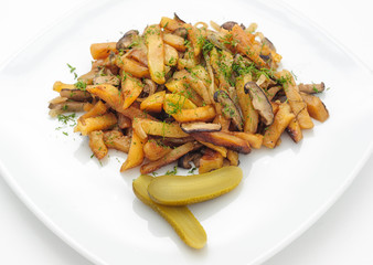 Fried potatoes and mushrooms with marinated cucumber isolated on white.