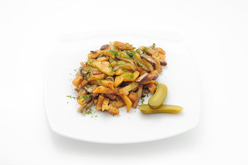 Fried potatoes and mushrooms with marinated cucumber isolated on white.