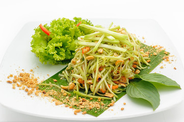 Spicy papaya salad Thai style isolated on white