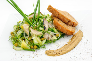Marinated herring with greenery, mustard and fried bred isolated on white.
