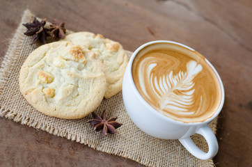 Obraz na płótnie Canvas hot coffee and white chocolate macadamia cookie