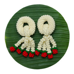 Knitting garland on banana leaf isolated on white background