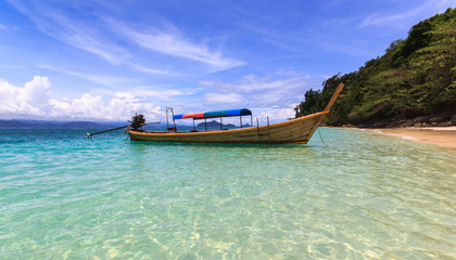 Fototapeta na wymiar Fisherman boat float in blue sea with white sand beach and beautiful blue sky.Kangkao island.