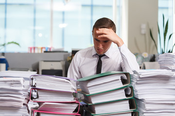Stressful manager have so many paperwork in the office