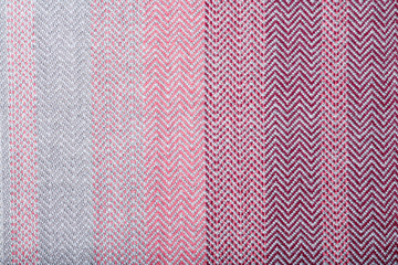 Handmade fabric with pink and gray striped texture. Clothes background