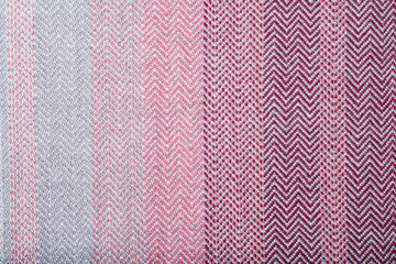 Handmade fabric with pink and gray striped texture. Clothes background