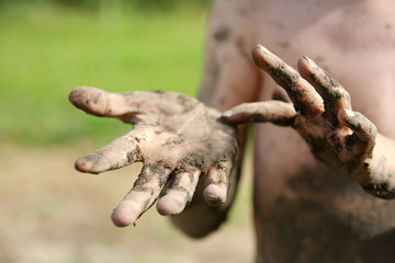 Close up on Muddy Hands of Little Boy
