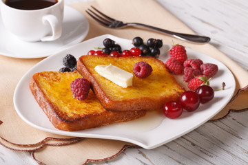 Two sweet toast with honey and berries close-up. Horizontal
