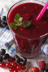 Homemade smoothies with raspberries and currants vertical macro
