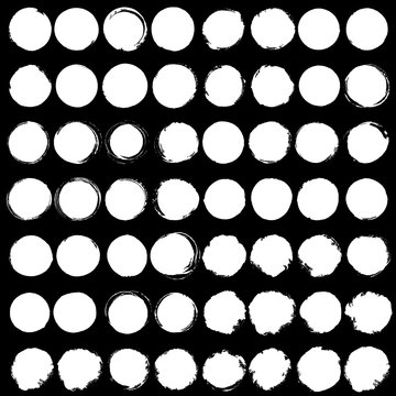 Set of Big white grunge silhouette circles on black background.