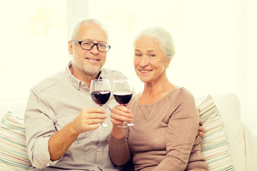 happy senior couple with glasses of red wine