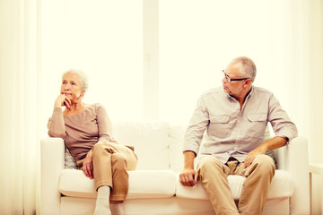 senior couple sitting on sofa at home