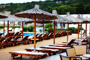 Beach umbrellas at the hotel lounge chairs