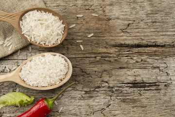 different rice in spoons on wooden background. Healthy eating, diet, vegetarianism.