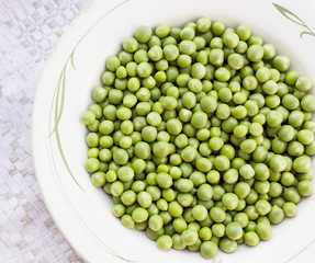 Green peas on the vintage linen background